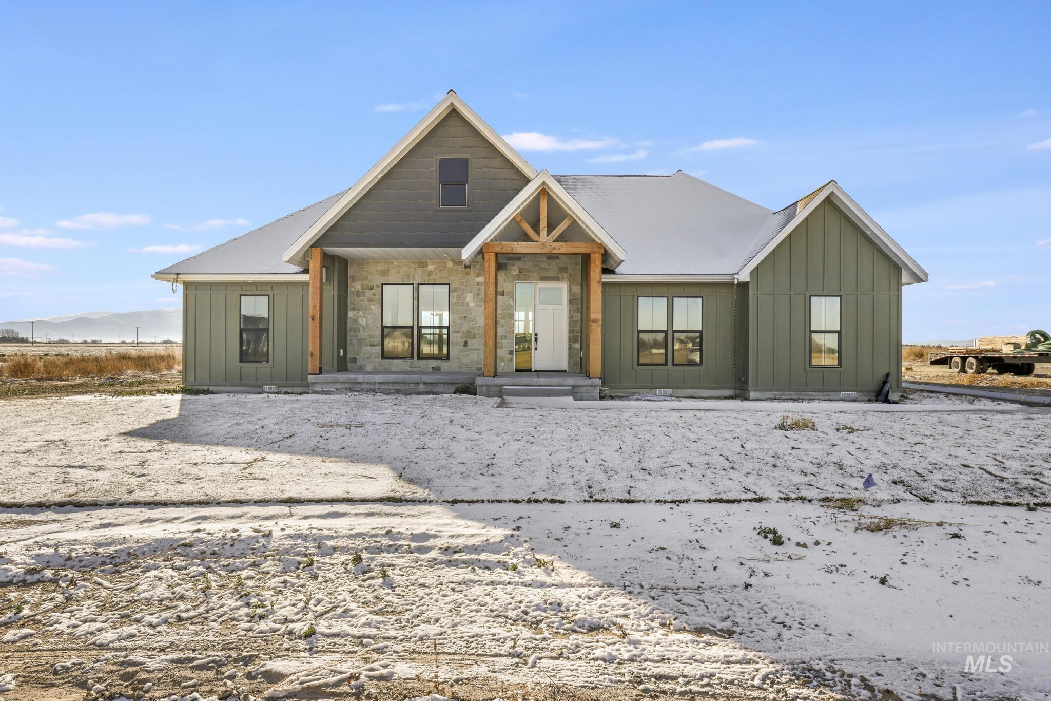 View of front facade with board and batten siding and a porch
