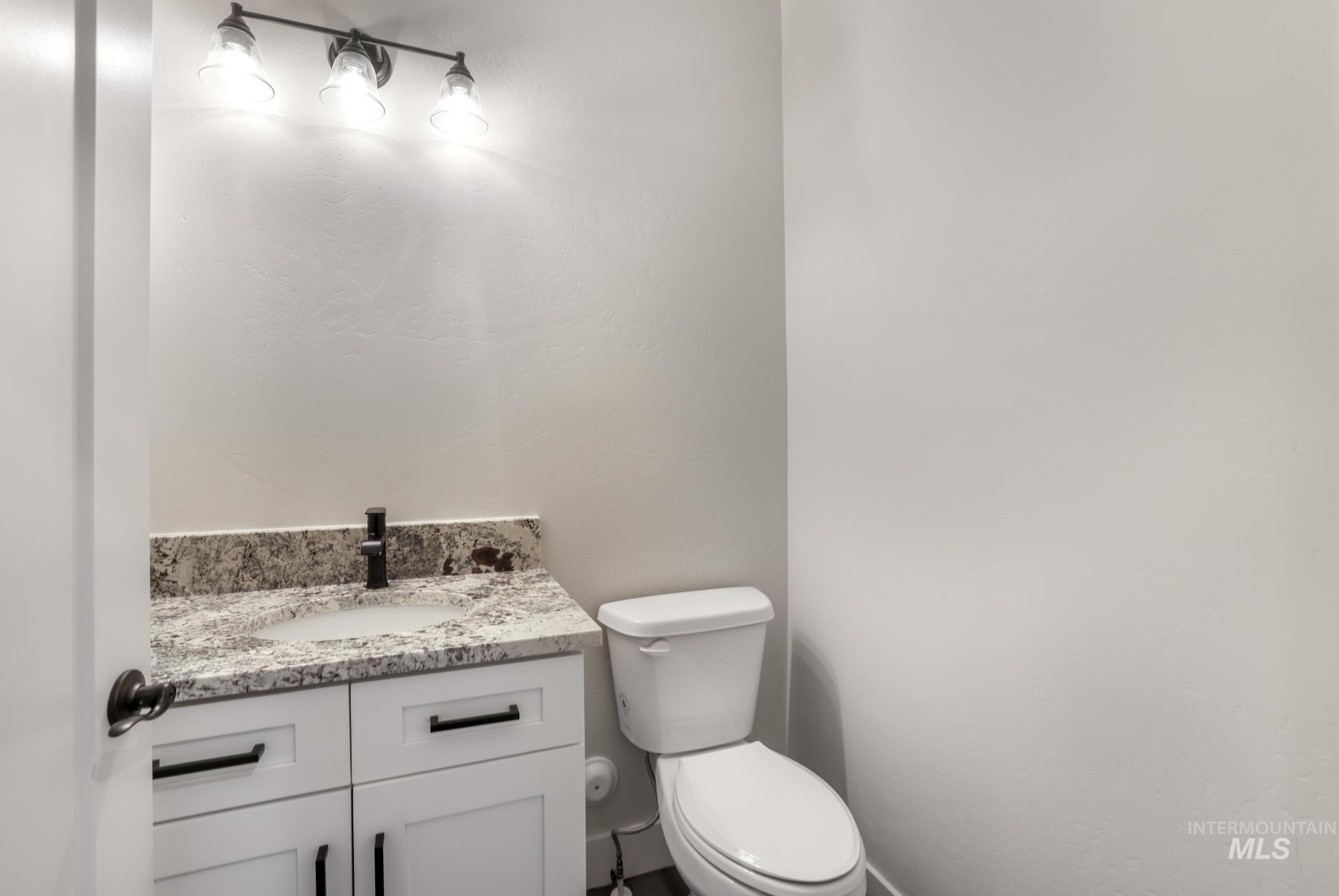 Half bath with vanity and toilet