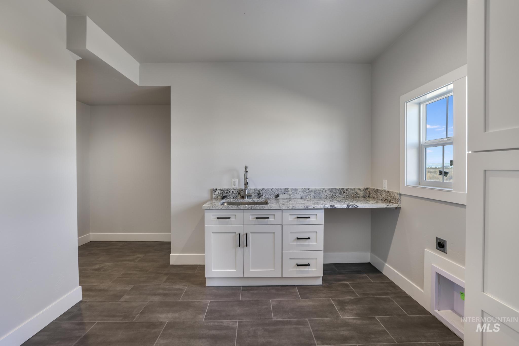 Laundry room with electric dryer hookup and cabinet space