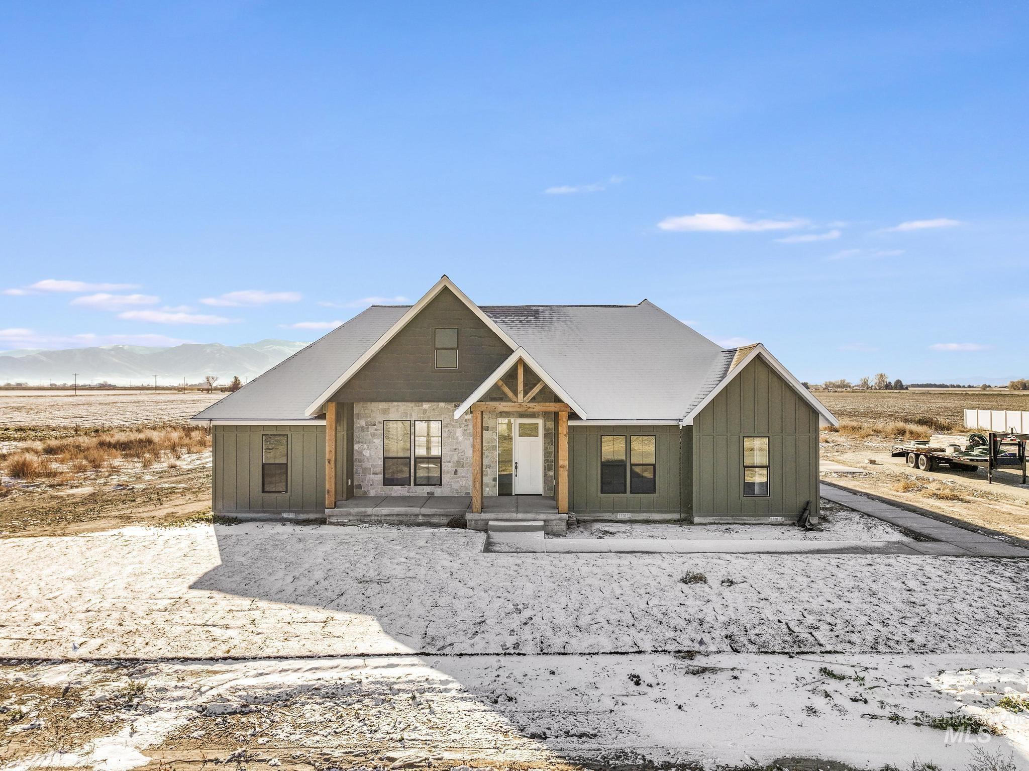 Chalet / cabin featuring covered porch, a view of countryside, and board and batten siding