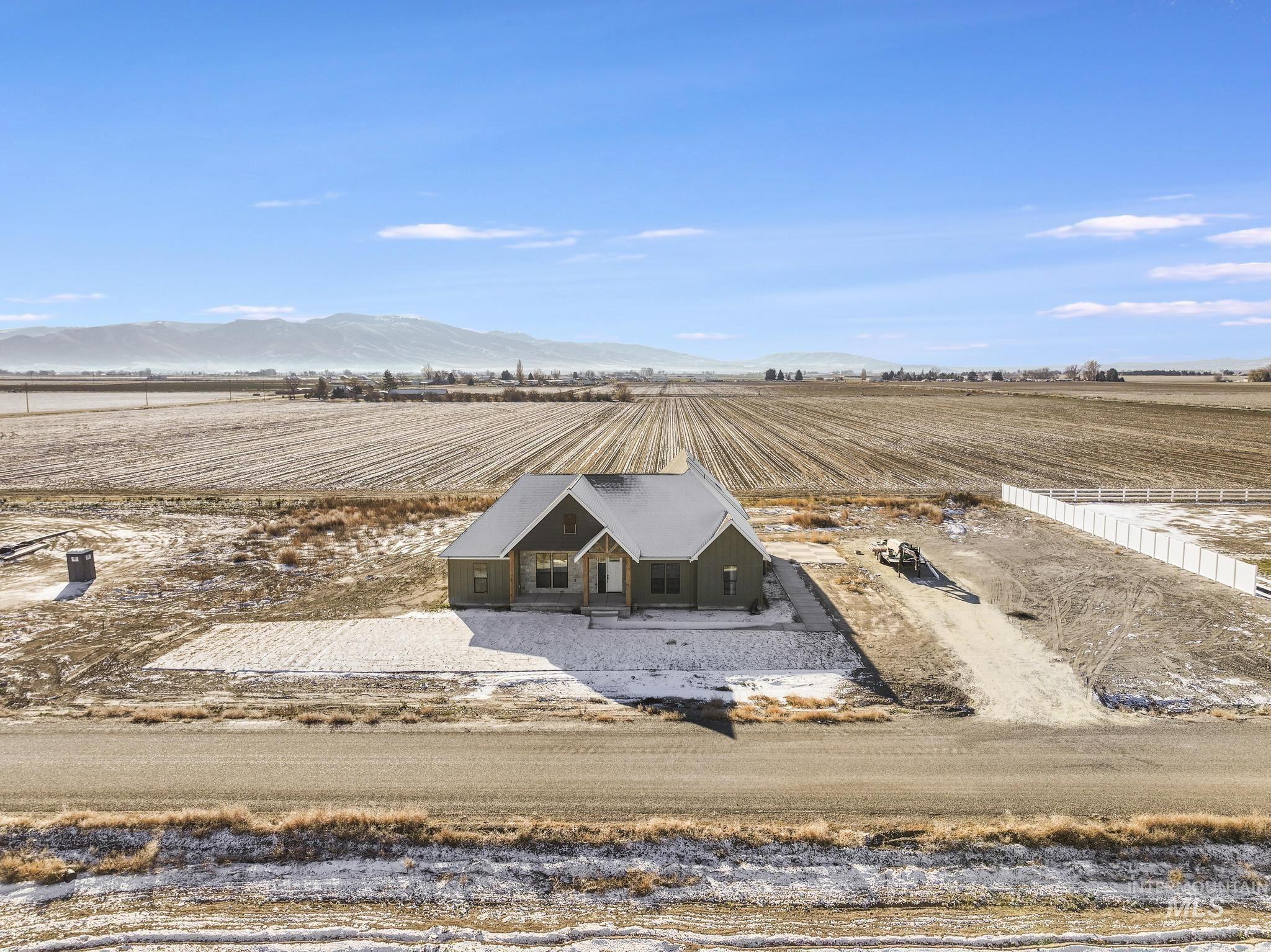Overview of rural landscape with farmland and a mountain backdrop