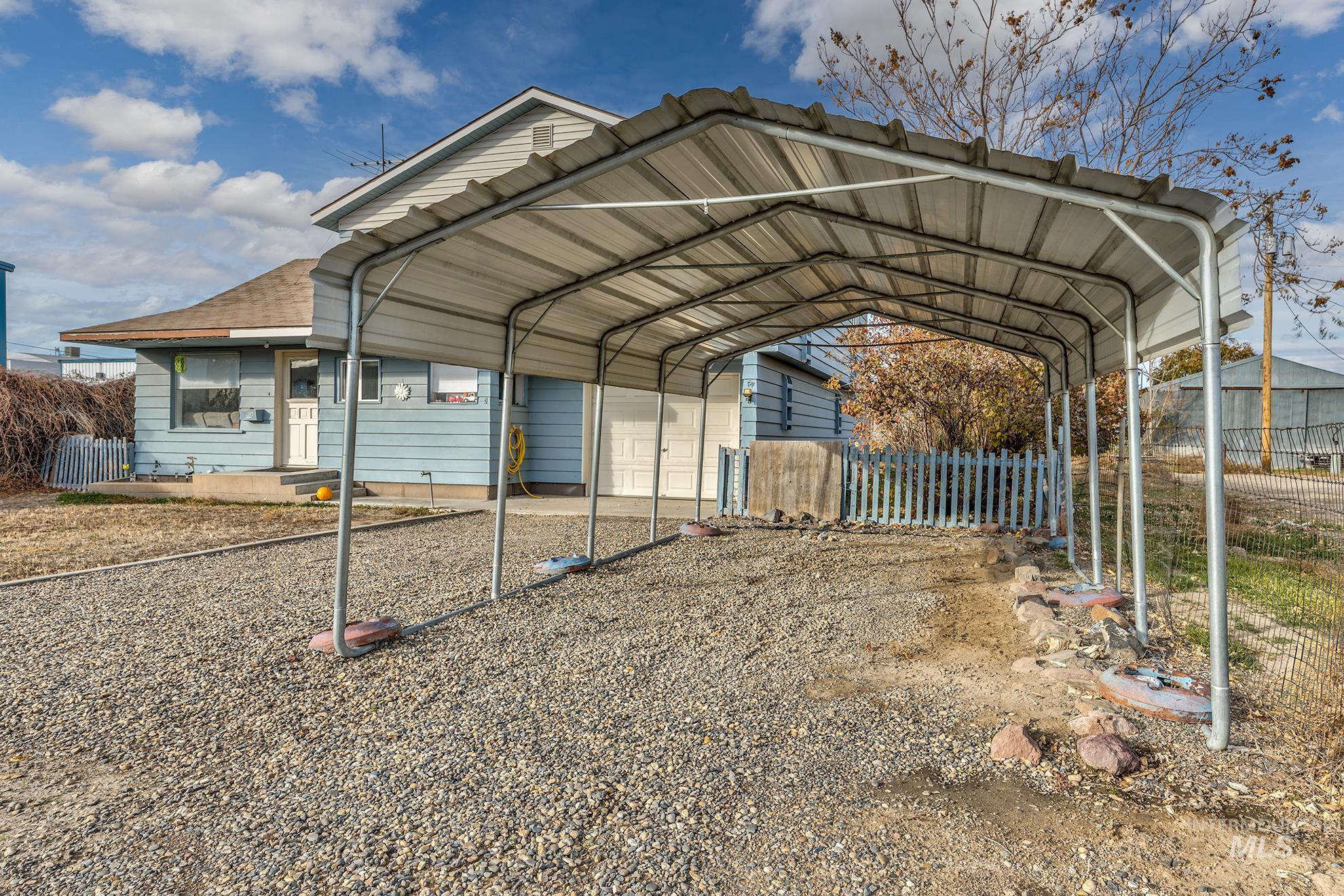 View of parking / parking lot with a detached carport