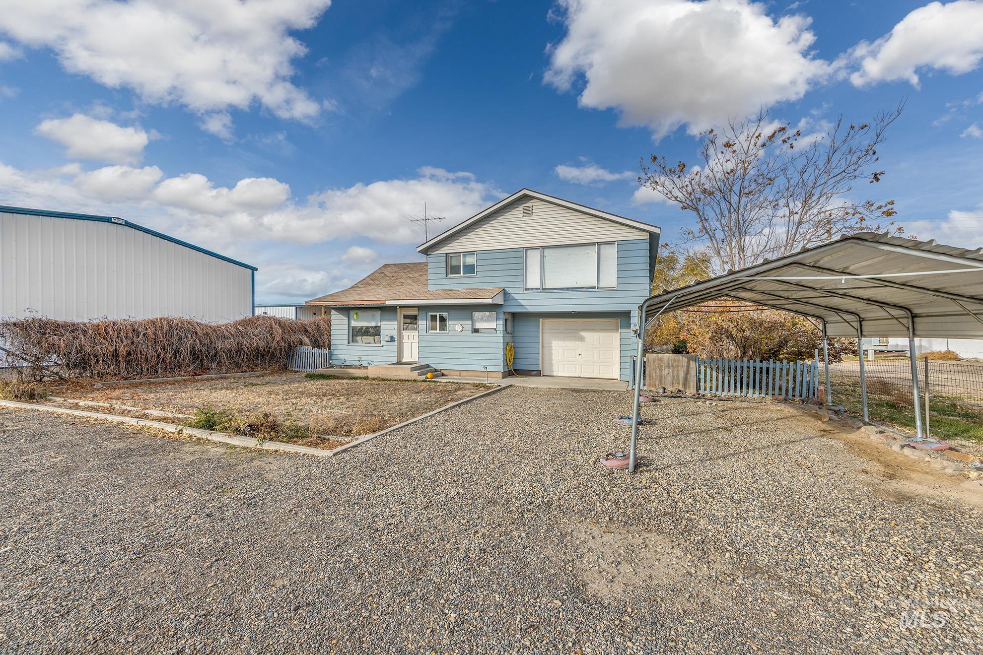 Traditional home with driveway, a garage, and a carport