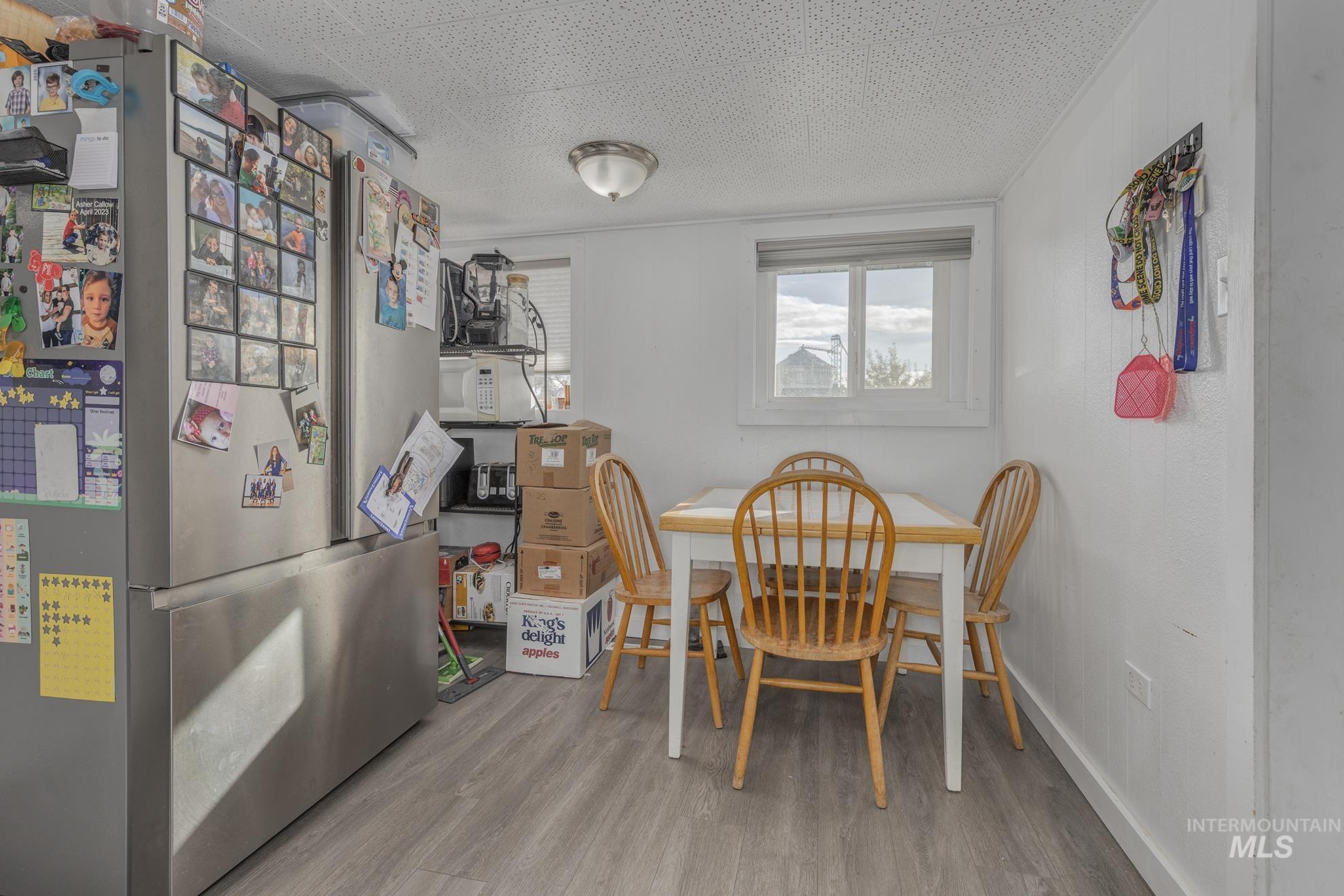 Dining area with wood finished floors and a textured ceiling